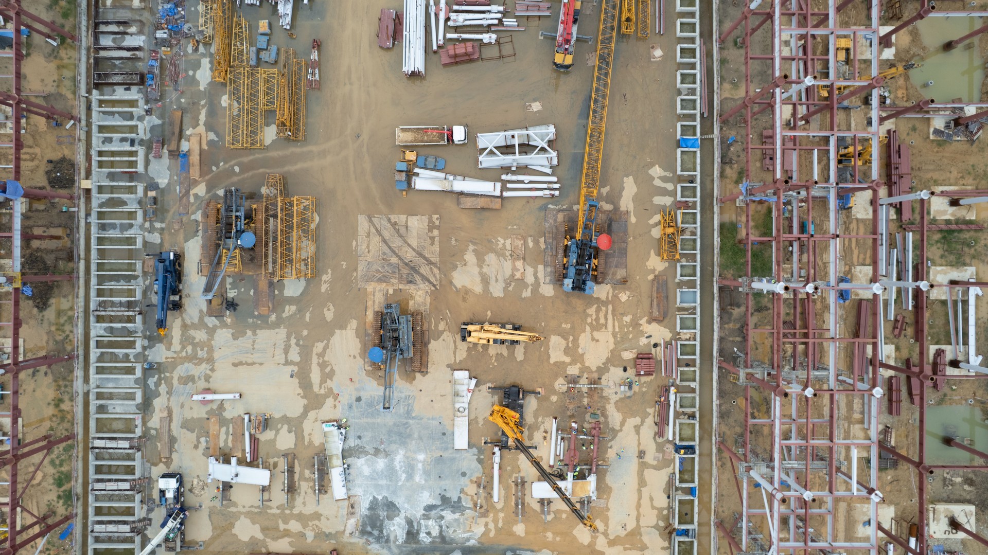 Aerial View of steel framing of new building or factory under construction, Technology and business Investment.