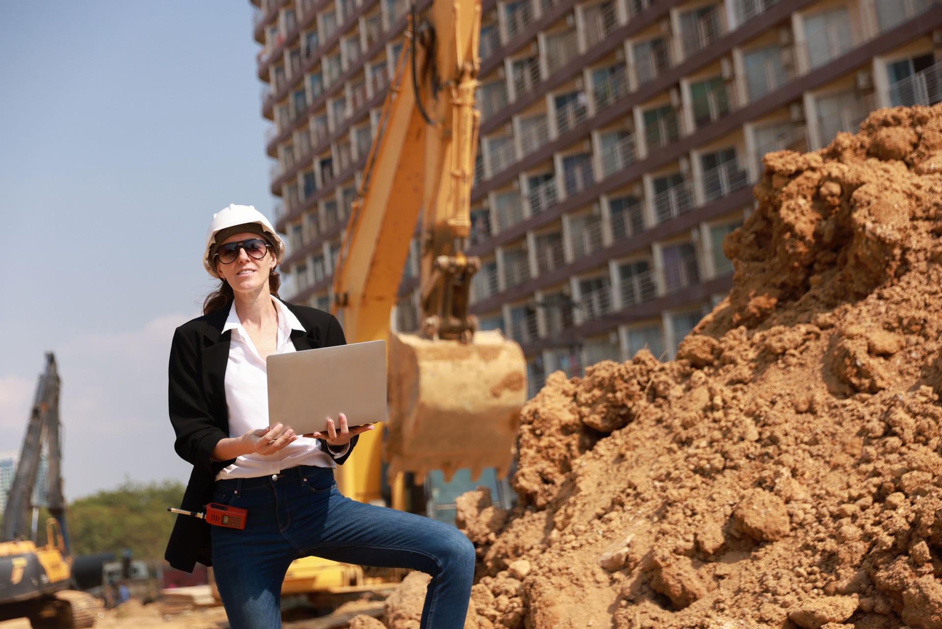 The senior female construction engineering project manager and senior construction supervising manager examined the plan document and blueprint of the large drainage pipe project and followed the progress and coworking at the construction site.